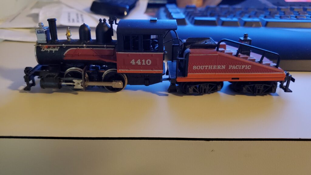 Model train engine on a desk surface.
