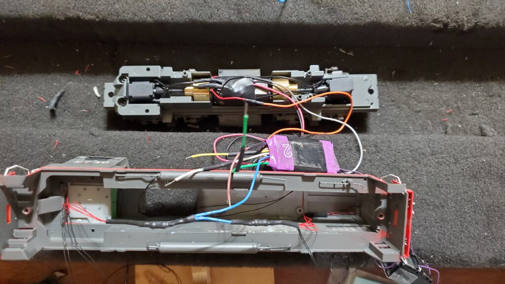 Disassembled electronic device with exposed wiring.